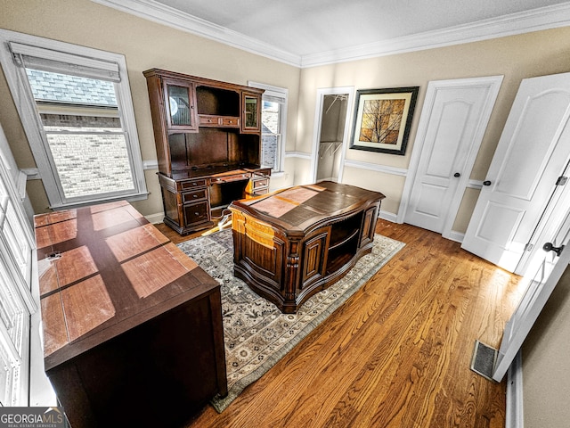 office featuring crown molding and light hardwood / wood-style floors