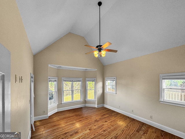 unfurnished room with hardwood / wood-style flooring, a wealth of natural light, and ceiling fan