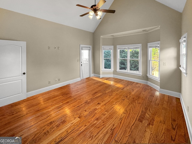 unfurnished room featuring ceiling fan, high vaulted ceiling, and light wood-type flooring