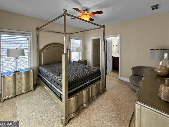 bedroom featuring ceiling fan, ensuite bathroom, and carpet