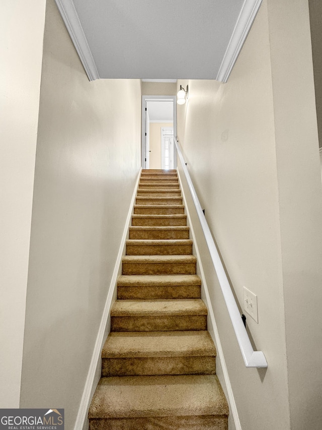 staircase featuring ornamental molding