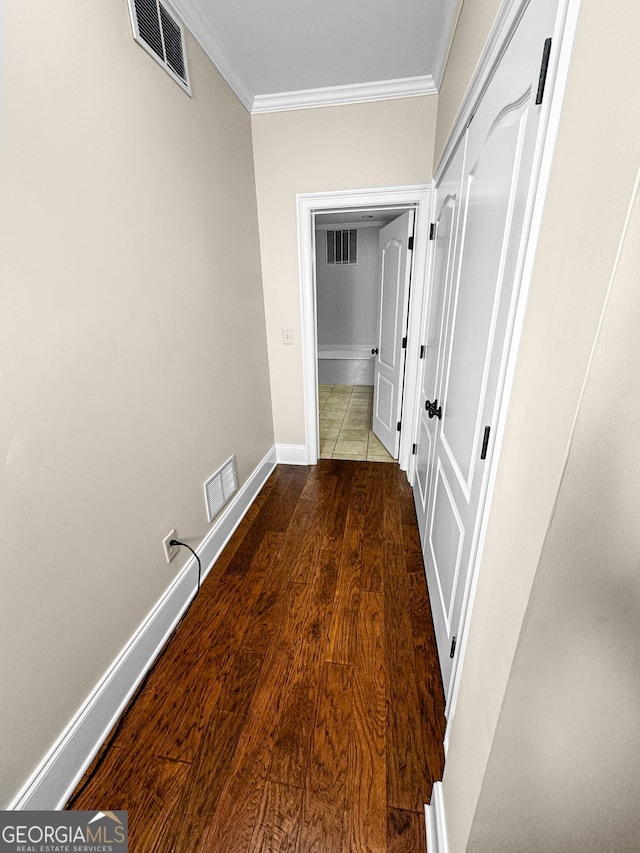 hall with dark hardwood / wood-style flooring and ornamental molding