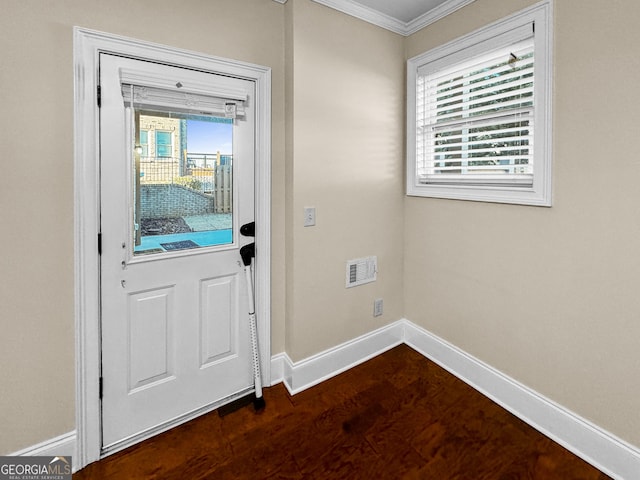 doorway to outside featuring crown molding and dark hardwood / wood-style floors