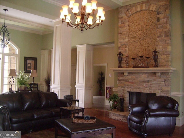 living room featuring a fireplace, a chandelier, a high ceiling, crown molding, and dark wood-type flooring