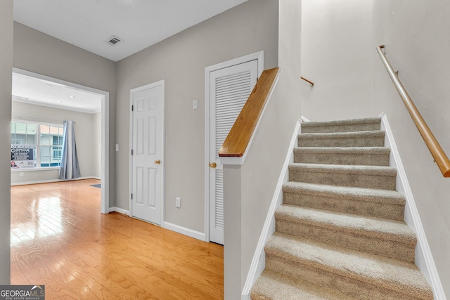 stairs with hardwood / wood-style floors