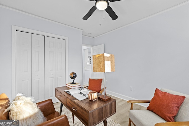 office featuring ceiling fan, light wood-type flooring, and ornamental molding