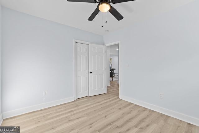 spare room featuring light hardwood / wood-style floors and ceiling fan