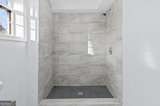 bathroom with a tile shower