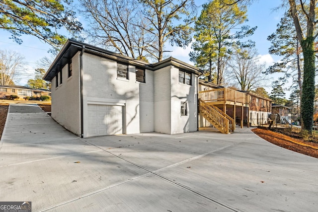 exterior space featuring a garage and a wooden deck