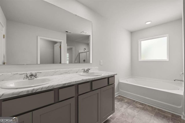 bathroom with vanity and independent shower and bath