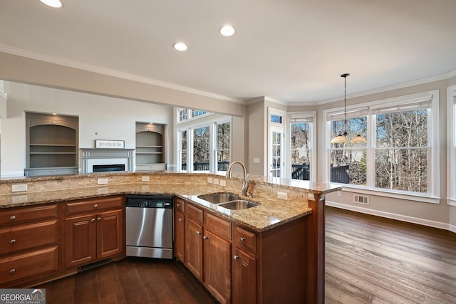 kitchen with a sink, crown molding, brown cabinetry, and dishwasher