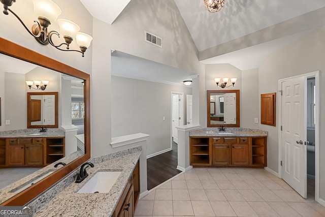 full bathroom with two vanities, a sink, visible vents, and tile patterned floors