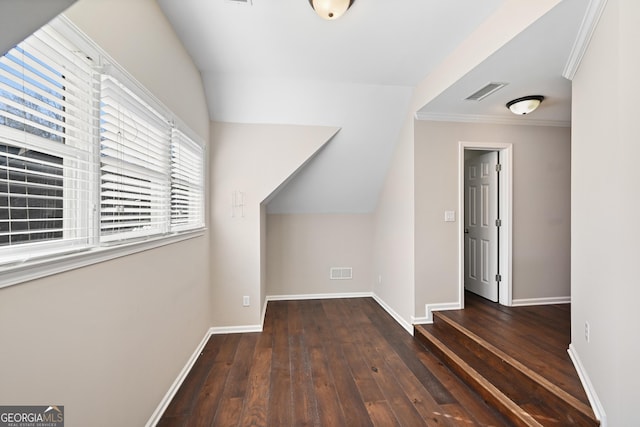 additional living space featuring lofted ceiling, hardwood / wood-style flooring, baseboards, and visible vents