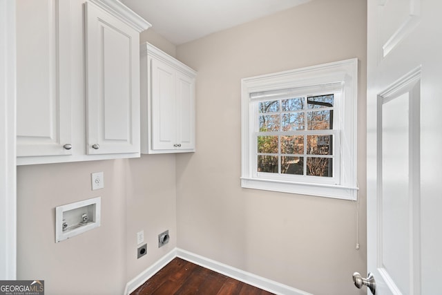 clothes washing area featuring dark wood finished floors, hookup for a washing machine, cabinet space, hookup for an electric dryer, and baseboards