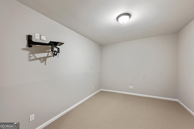 empty room with baseboards and light colored carpet