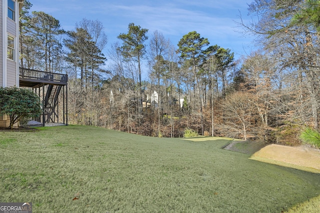 view of yard with a wooden deck and stairs