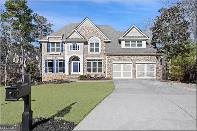 craftsman house with a garage, driveway, a front lawn, and roof with shingles