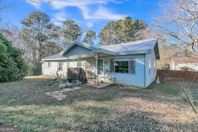 rear view of property with a lawn