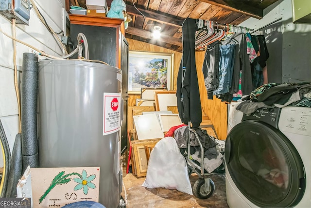 utility room with electric water heater and washer / dryer