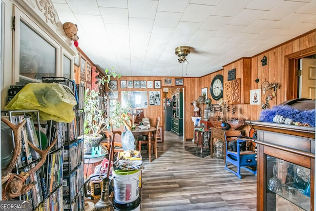 misc room featuring hardwood / wood-style floors and wooden walls