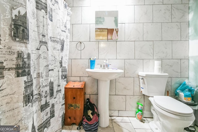 bathroom with a shower with curtain and toilet