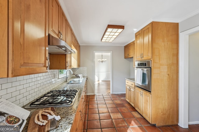 kitchen with backsplash, light stone countertops, ornamental molding, and appliances with stainless steel finishes