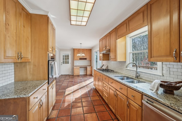 kitchen featuring sink, dark tile patterned floors, crown molding, pendant lighting, and appliances with stainless steel finishes