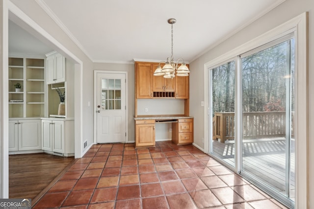 kitchen featuring a chandelier, hanging light fixtures, ornamental molding, and light tile patterned flooring