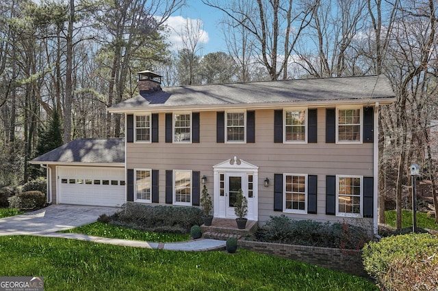 colonial house with a front lawn and a garage