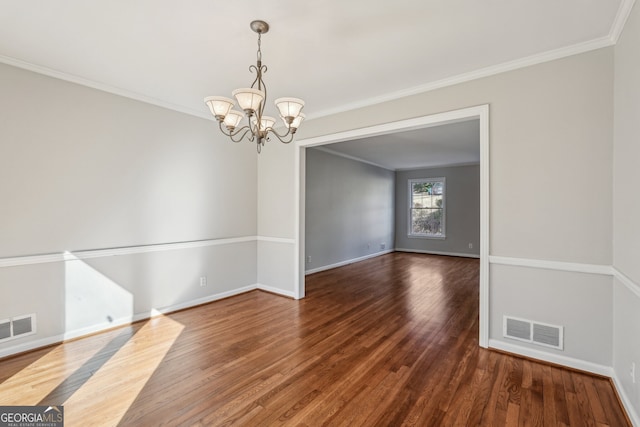 unfurnished room featuring an inviting chandelier, dark wood-type flooring, and crown molding