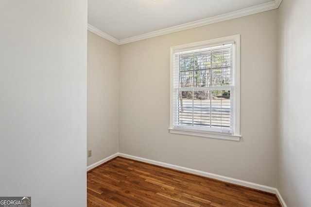 spare room featuring dark hardwood / wood-style floors and crown molding