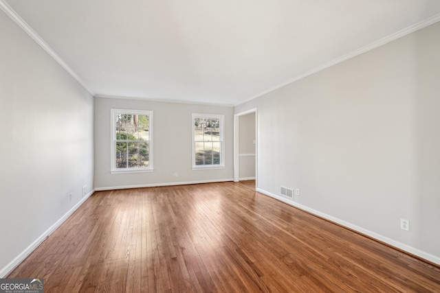 unfurnished room with hardwood / wood-style floors and crown molding