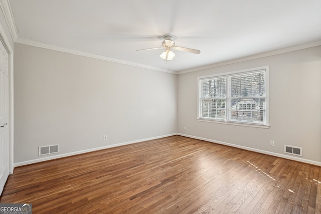 unfurnished room with ceiling fan, wood-type flooring, and crown molding