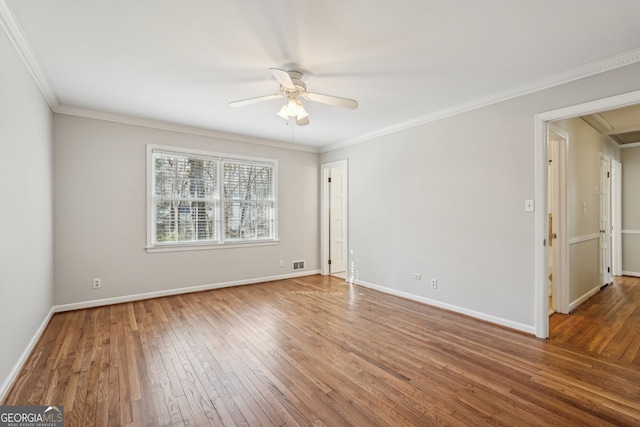 spare room featuring ceiling fan, wood-type flooring, and ornamental molding