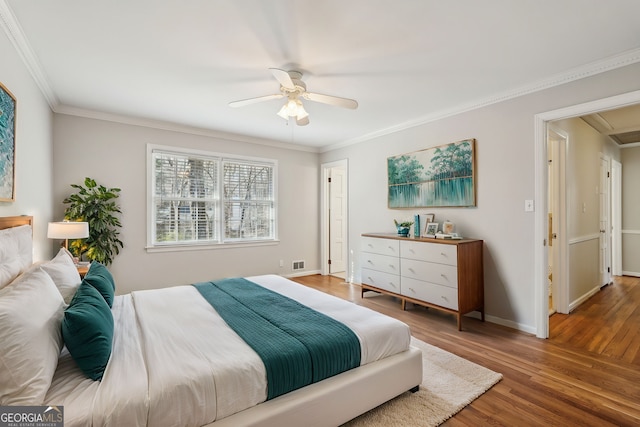 bedroom with dark hardwood / wood-style flooring, ceiling fan, and crown molding