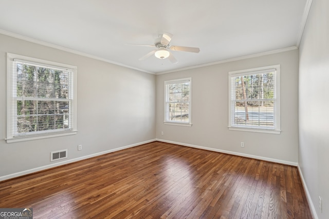 unfurnished room with dark hardwood / wood-style floors, a healthy amount of sunlight, ornamental molding, and ceiling fan