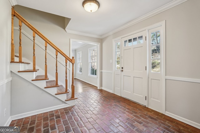 entrance foyer featuring a wealth of natural light and ornamental molding