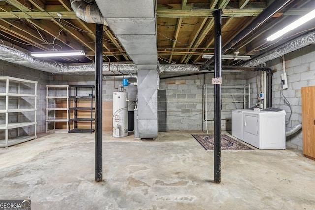 basement with water heater and washer and clothes dryer