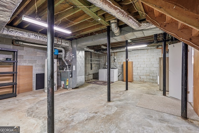 basement with heating unit and independent washer and dryer