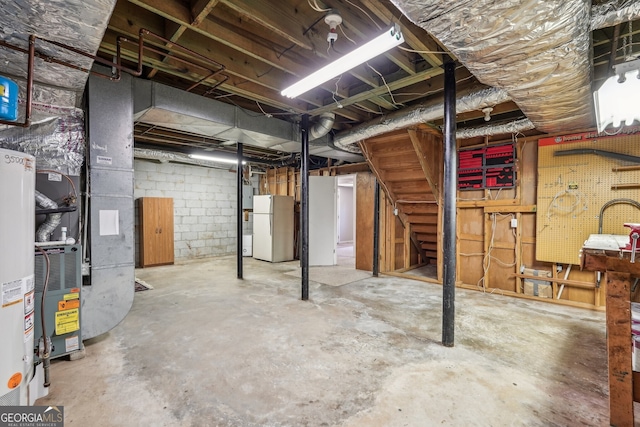 basement featuring a workshop area and white fridge