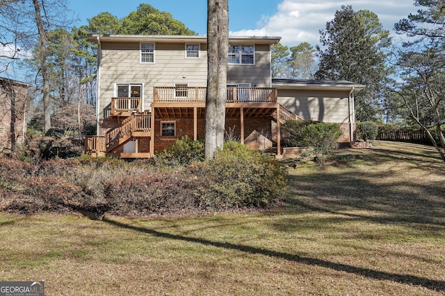 back of house featuring a lawn and a deck