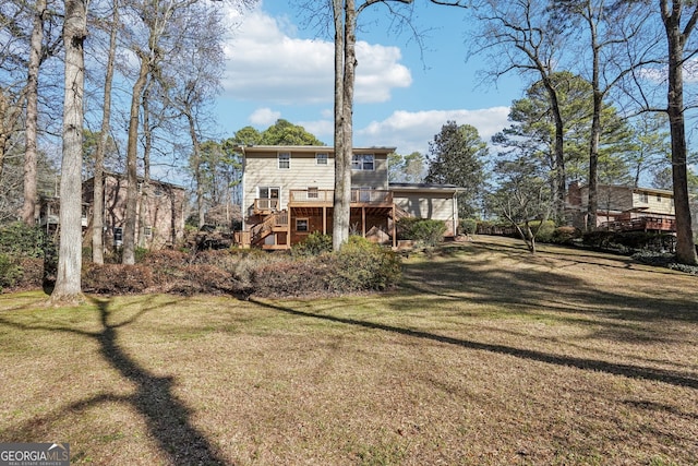 back of house with a lawn and a deck