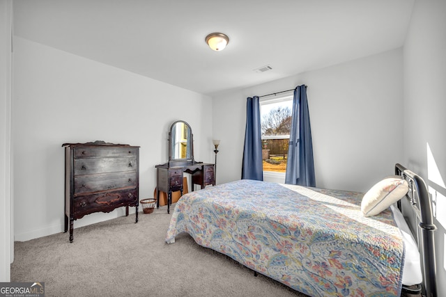 bedroom featuring light carpet