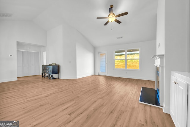 unfurnished living room with vaulted ceiling, ceiling fan, and light hardwood / wood-style floors