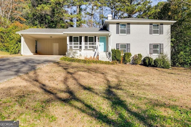 tri-level home with covered porch and a carport