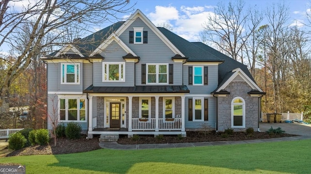 view of front of property with a porch and a front yard