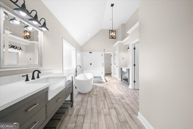 bathroom featuring hardwood / wood-style flooring, vanity, shower with separate bathtub, and a notable chandelier