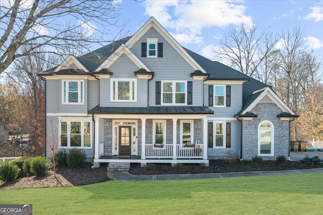 view of front of house featuring covered porch and a front yard