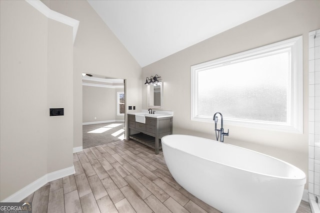 bathroom with a bathtub, vanity, lofted ceiling, and hardwood / wood-style flooring