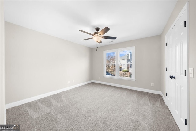 carpeted empty room with ceiling fan